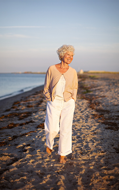smiling senior woman walking on the beach three core principles long beach ca